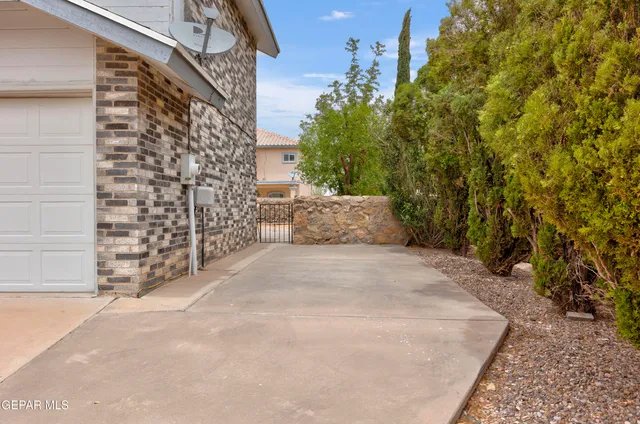 a view of a house with a yard covered in snow