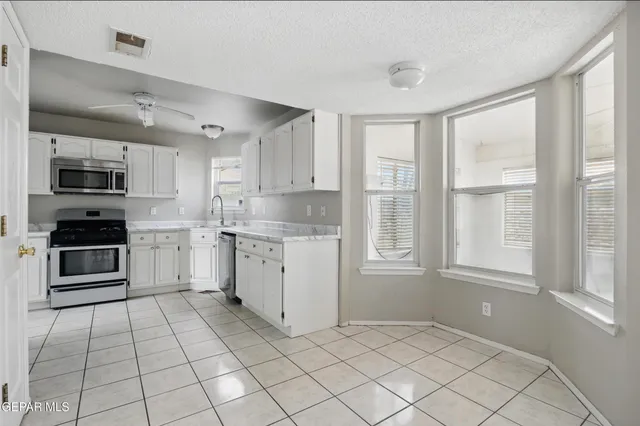 a kitchen with a stove a sink and a microwave