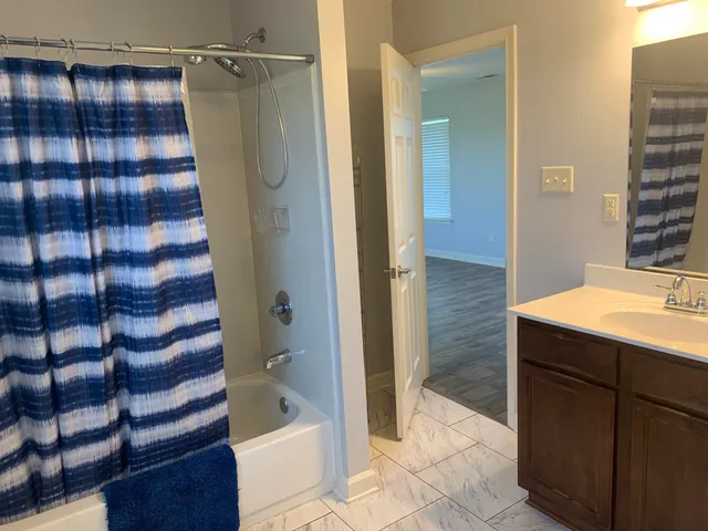 a bathroom with a bathtub and a shower