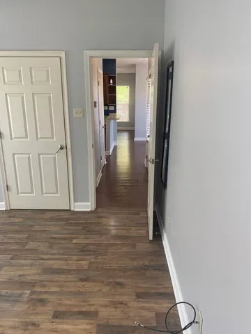 a view of a hallway with wooden floor