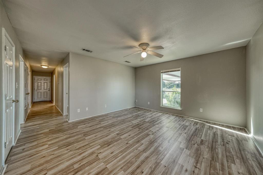 777 Olive Branch Road Weatherford, TX 76087 - Photo 1 of 20 a view of an empty room with window and wooden floor