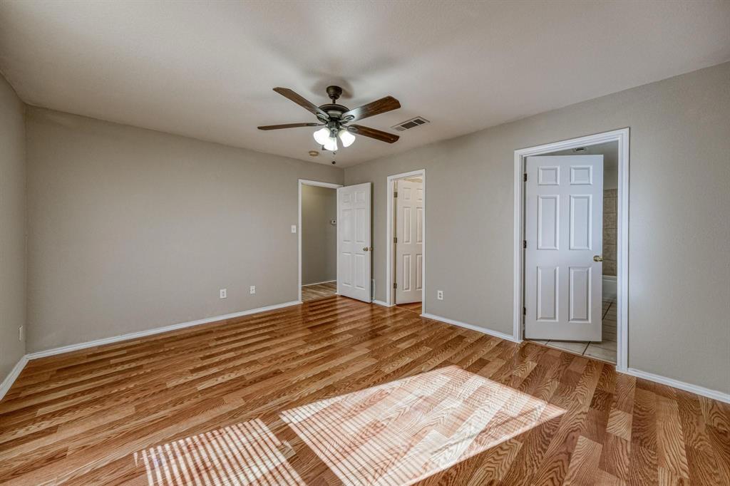 777 Olive Branch Road Weatherford, TX 76087 - Photo 17 of 20 a view of a room with a ceiling fan and wooden floor