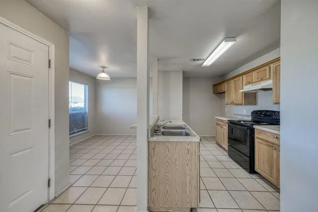 a kitchen with stainless steel appliances granite countertop a stove and a sink