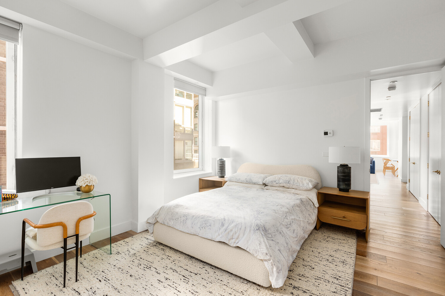 93 Worth Street, Unit 1201 Manhattan, NY 10013 - Photo 4 of 15 a bedroom with a bed and a computer on top of it