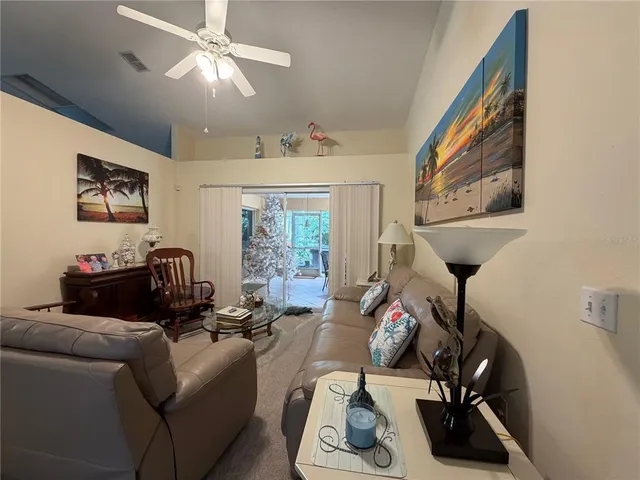 a living room with furniture a flat screen tv and a window