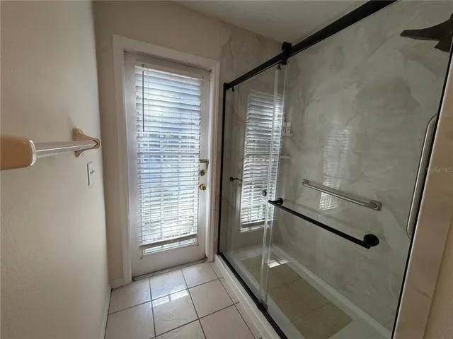 a bathroom with a glass shower door