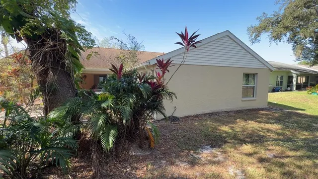 a view of a house with a yard and tree s