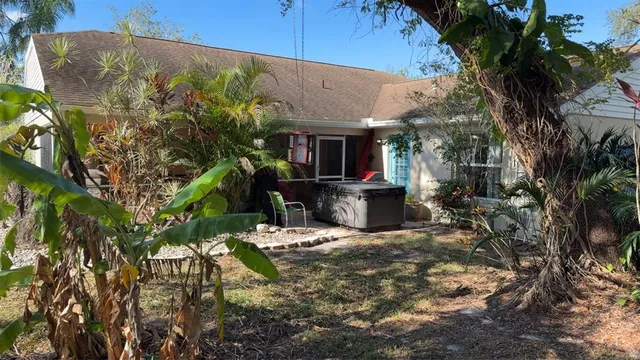 a view of house with yard and sitting area