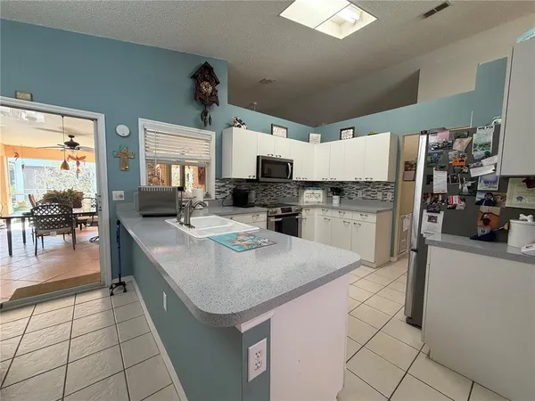 a kitchen with stainless steel appliances kitchen island granite countertop a sink and cabinets