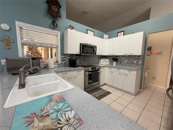 a kitchen with stainless steel appliances granite countertop a sink and a stove
