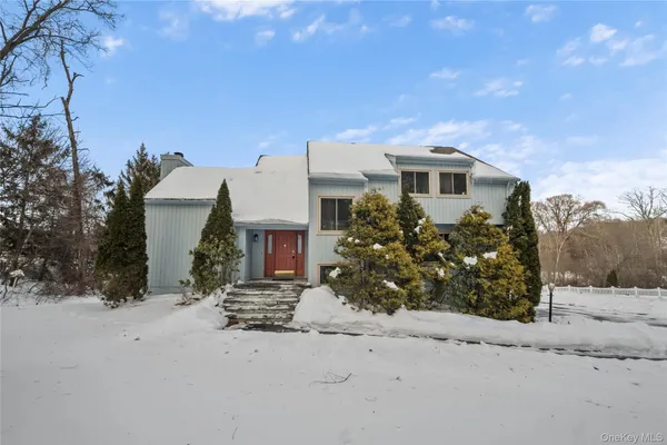a view of a house with a covered with snow in front of it