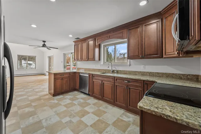 a kitchen with stainless steel appliances granite countertop a sink stove and granite counter tops