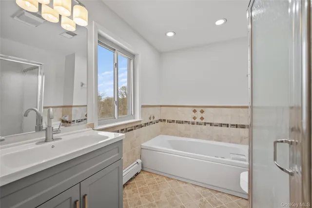 a bathroom with a bathtub and a sink