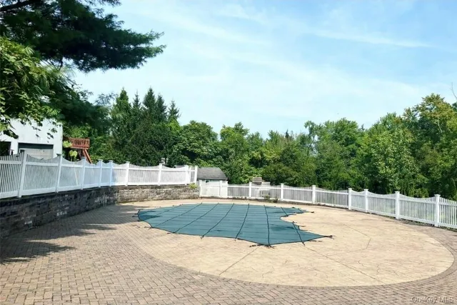 a view of a swimming pool with a yard