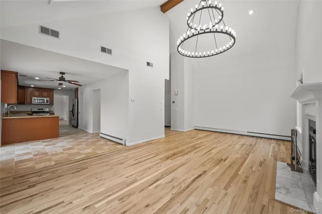 a view of a room with wooden floor and white walls