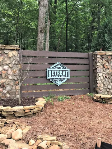 a view of a blue house with swimming pool in front of it
