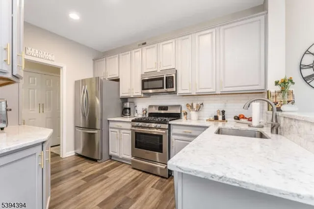 a kitchen with a sink stove and refrigerator