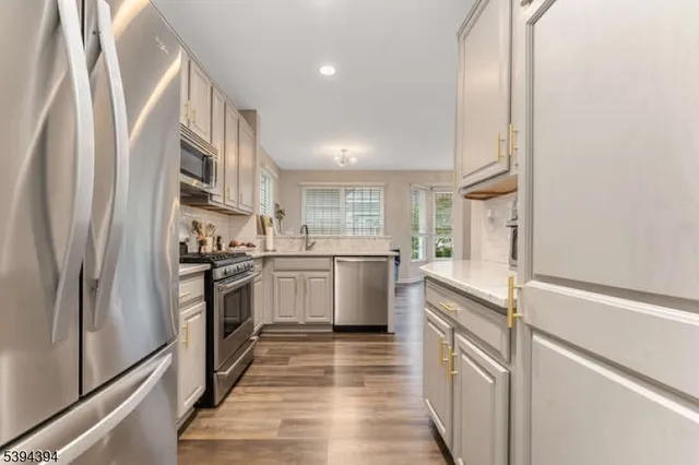 a kitchen with a sink stove and refrigerator