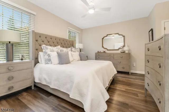 a large bed sitting in a bedroom next to a window and dresser