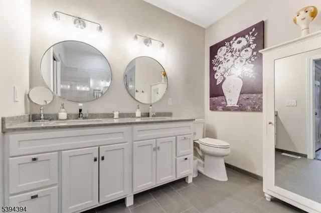 a bathroom with 2 sink and a mirror