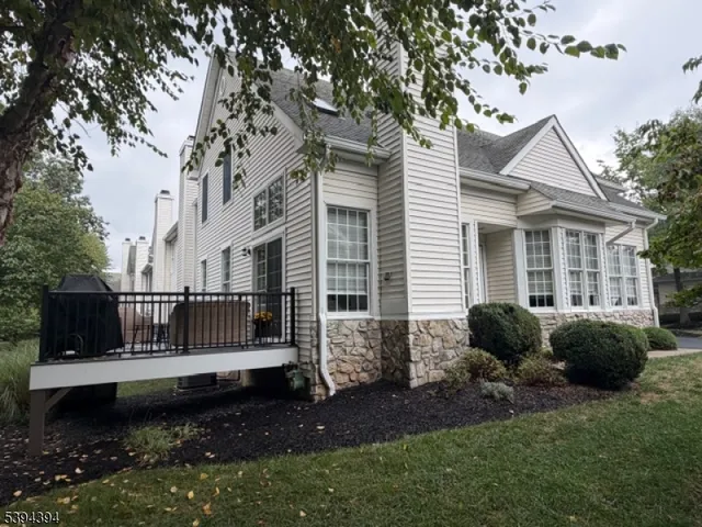 a front view of a house with garden and porch