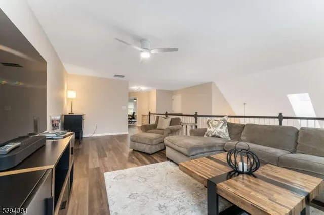 a living room with lots of furniture and a wooden floor