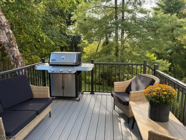 a view of a balcony with wooden floor and outdoor seating