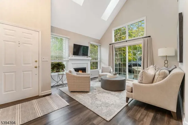 a living room with fireplace furniture and a large window