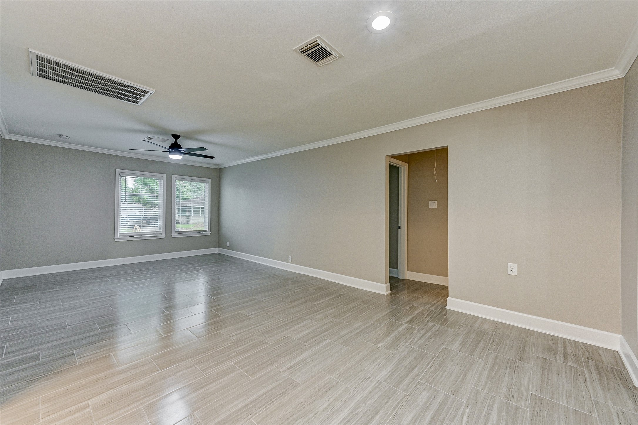 6618 Winton Street Houston, TX 77021 - Photo 11 of 20 an empty room with wooden floor and windows