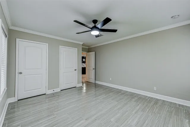 an empty room with wooden floor a ceiling fan and closet