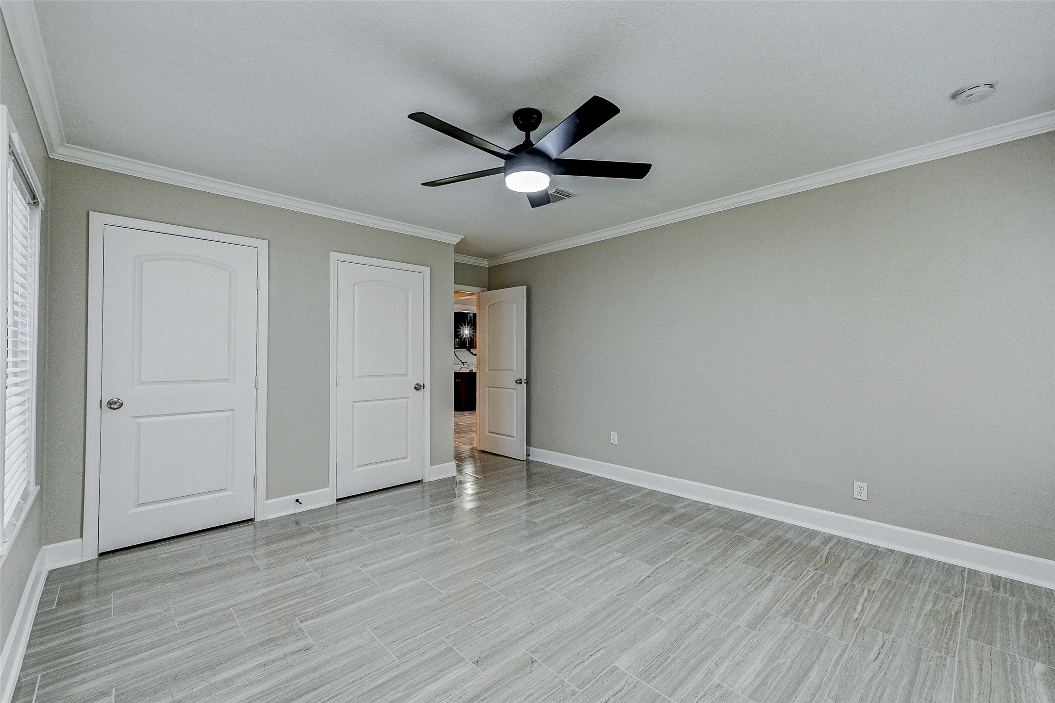 6618 Winton Street Houston, TX 77021 - Photo 12 of 20 an empty room with wooden floor a ceiling fan and closet