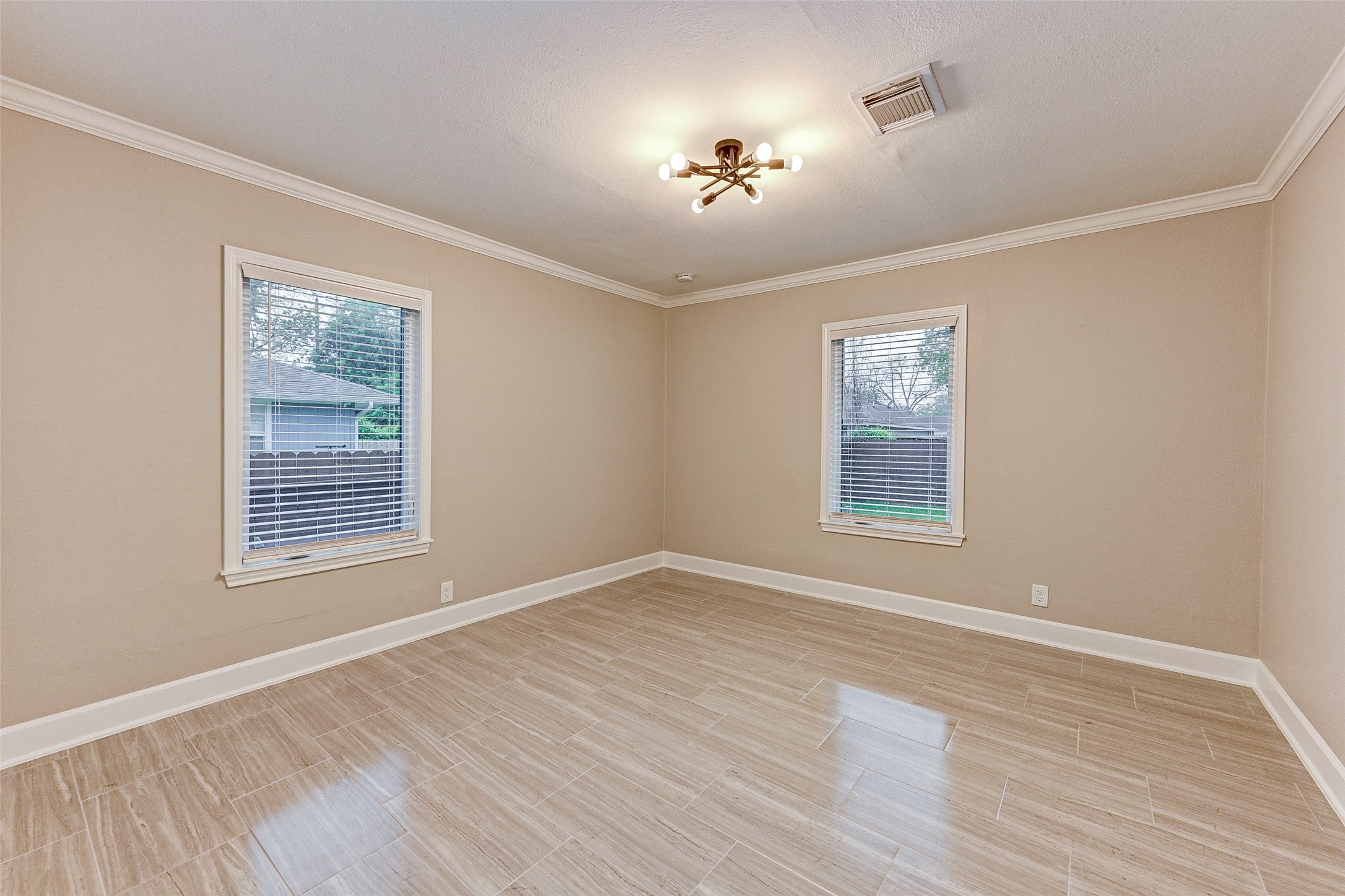 6618 Winton Street Houston, TX 77021 - Photo 13 of 20 a view of an empty room with wooden floor and a window