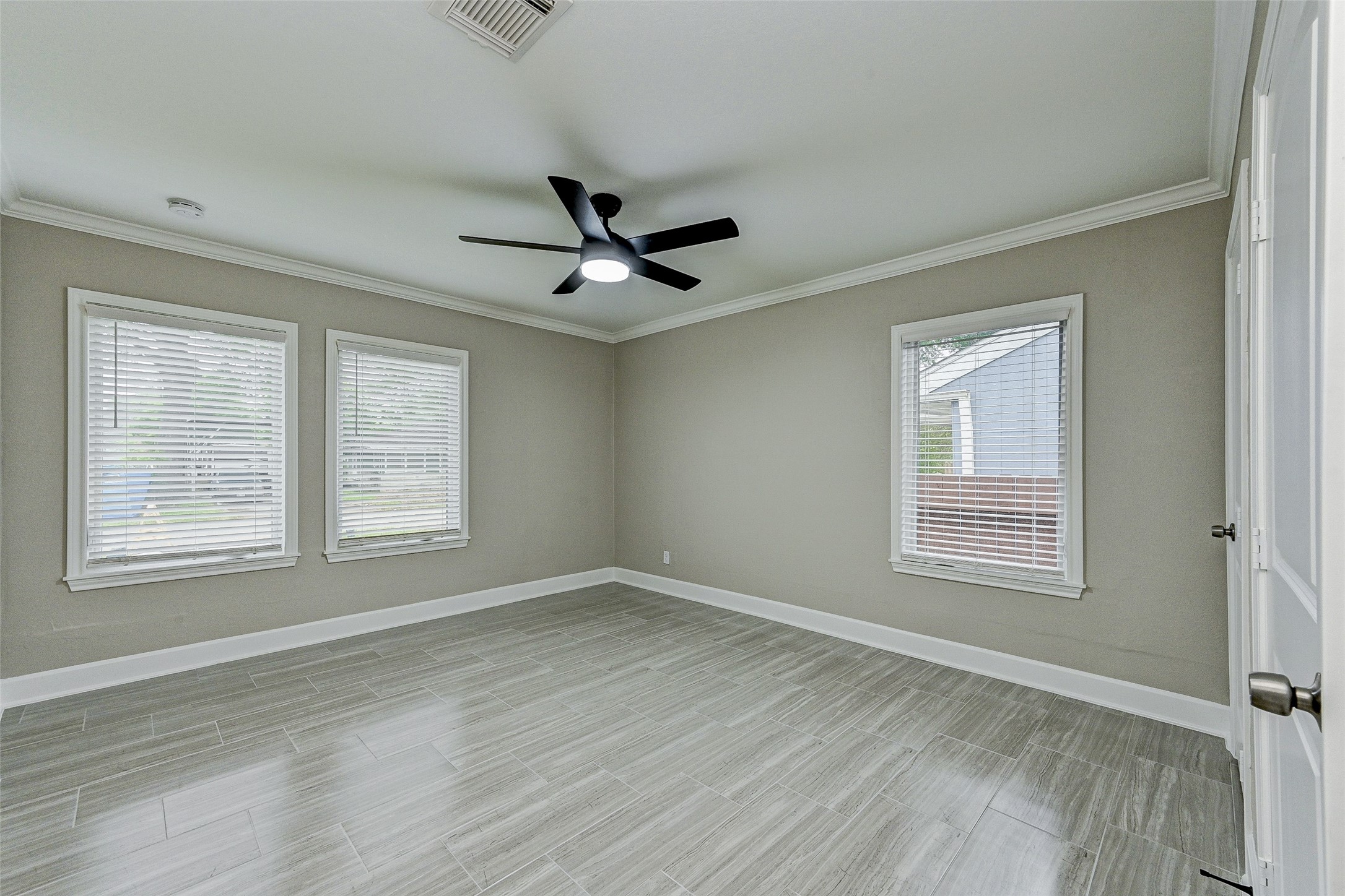 6618 Winton Street Houston, TX 77021 - Photo 14 of 20 a view of an empty room with a window and wooden floor