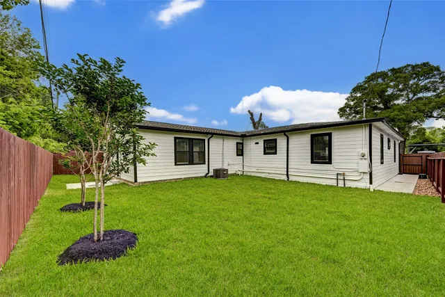 a backyard of a house with table and chairs