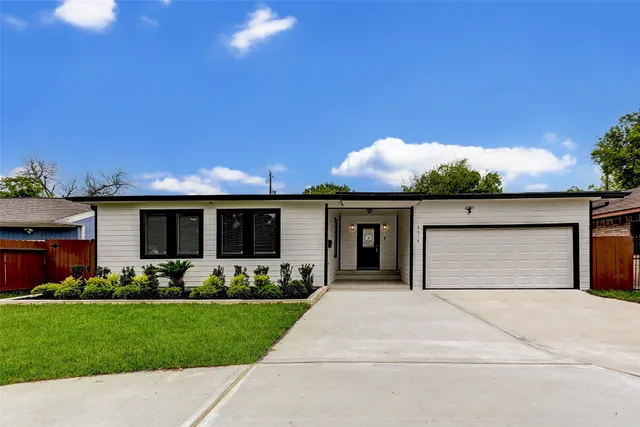 a front view of house with yard and outdoor seating