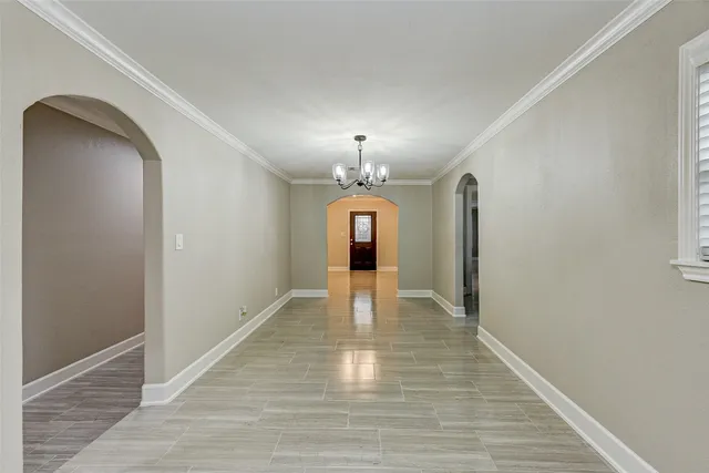 a view of a room with wooden floor closet and chandelier