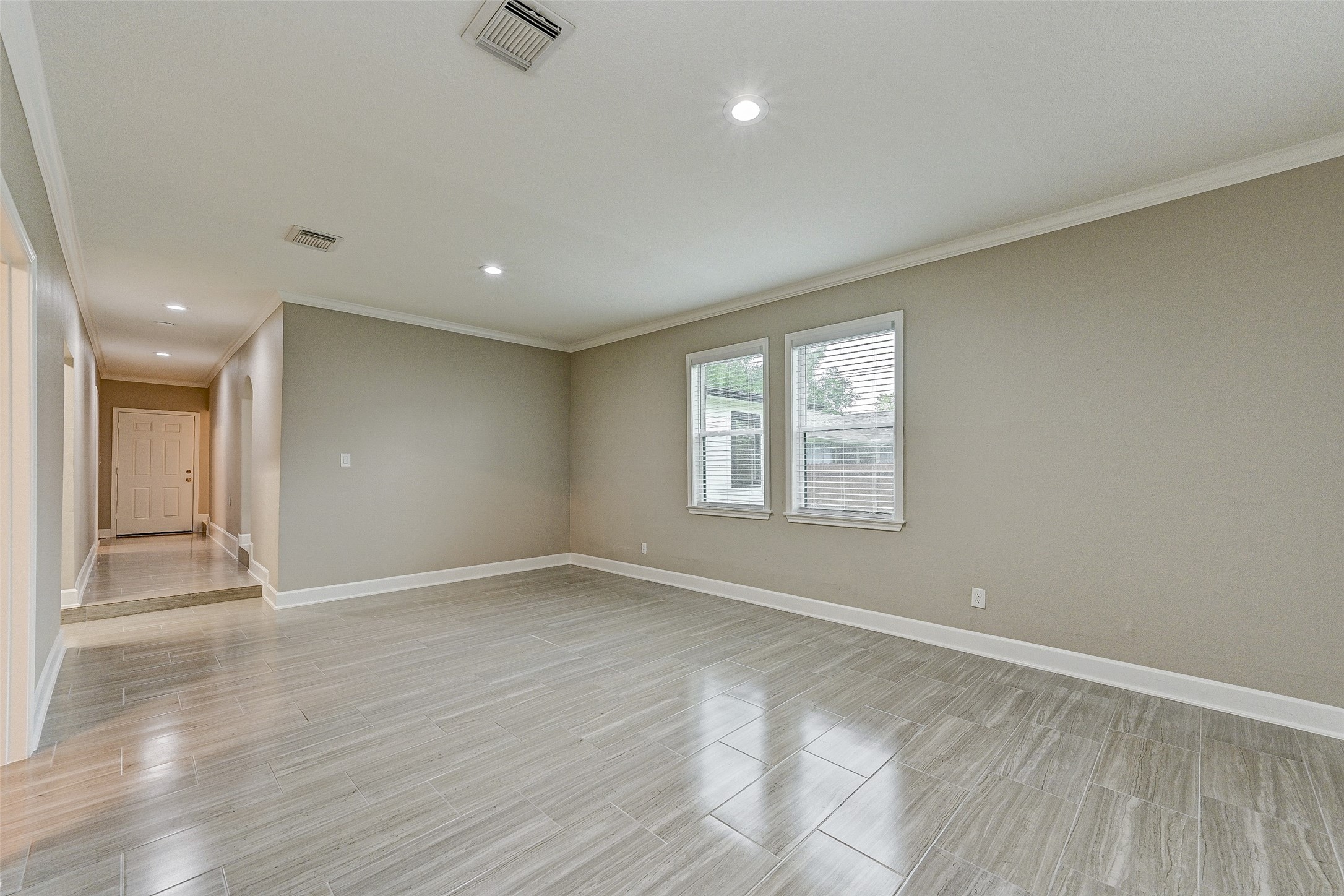6618 Winton Street Houston, TX 77021 - Photo 7 of 20 a view of an empty room with wooden floor and a window