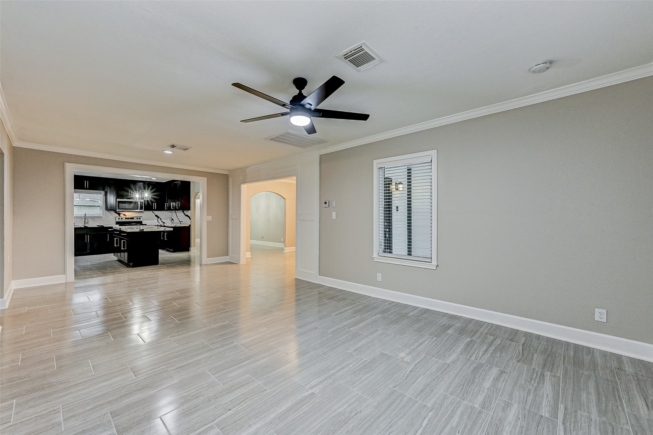 6618 Winton Street Houston, TX 77021 - Photo 8 of 20 a view of an empty room with a kitchen and a window