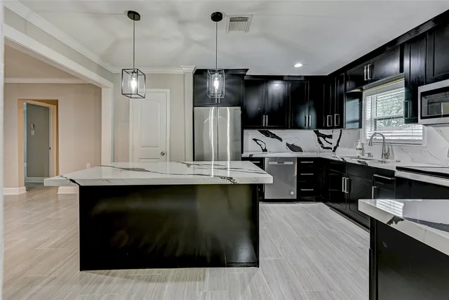 a kitchen with a sink stainless steel appliances and cabinets