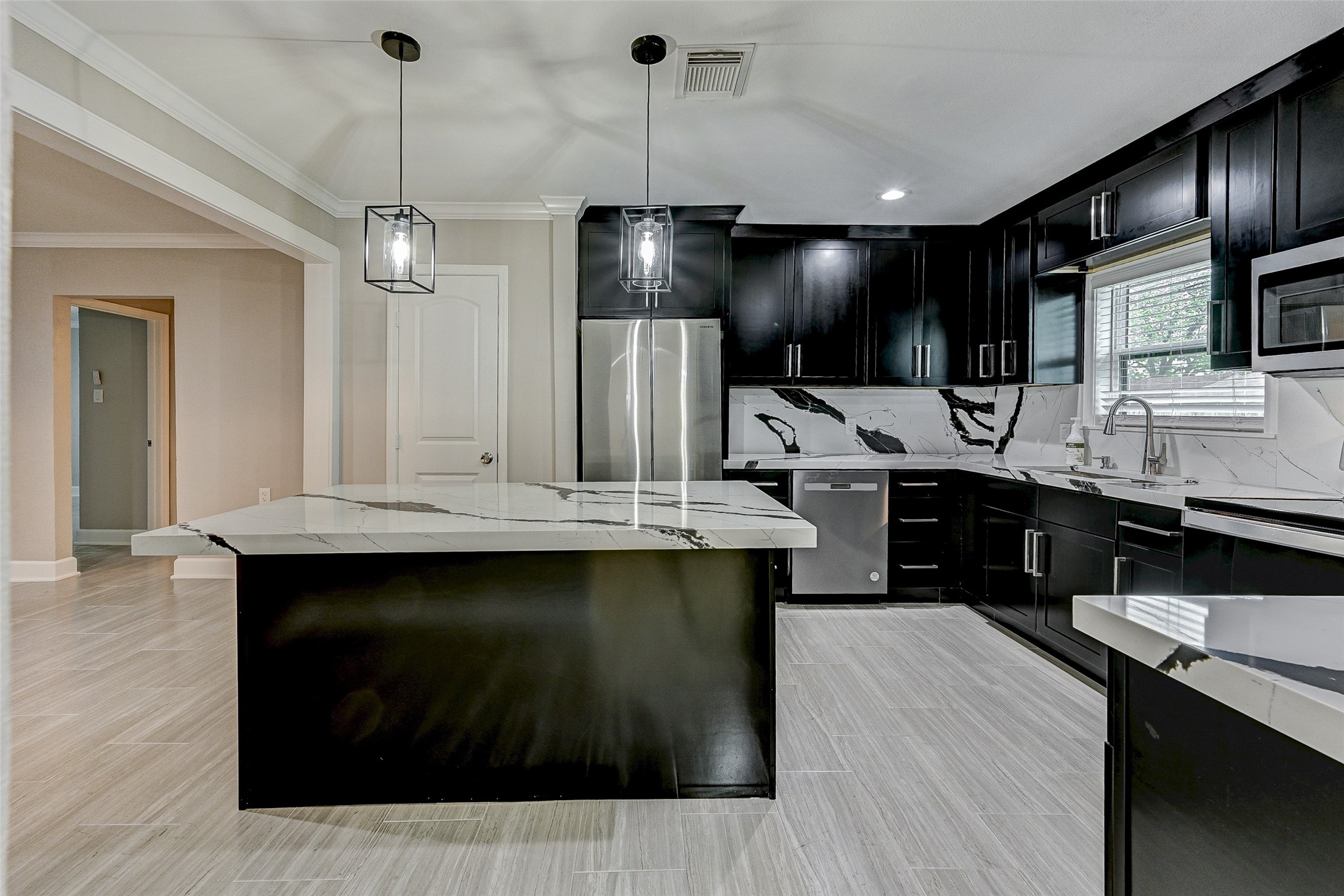 6618 Winton Street Houston, TX 77021 - Photo 9 of 20 a kitchen with a sink stainless steel appliances and cabinets