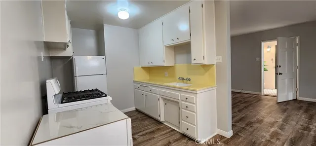 a kitchen with a refrigerator and a stove