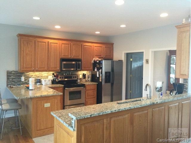 1331 Bethel Road Morganton, NC 28655 - Photo 7 of 10 a kitchen with stainless steel appliances granite countertop a refrigerator a sink a stove a microwave and island