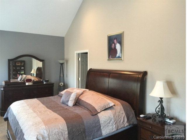 1331 Bethel Road Morganton, NC 28655 - Photo 9 of 10 a bedroom with a bed and a lamp on dresser