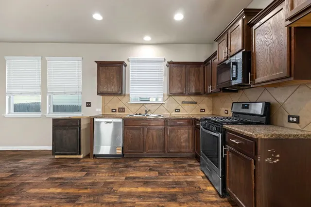 a view of an empty room with window and cabinet