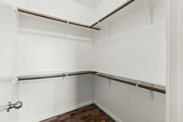 an empty room with a window and a ceiling fan