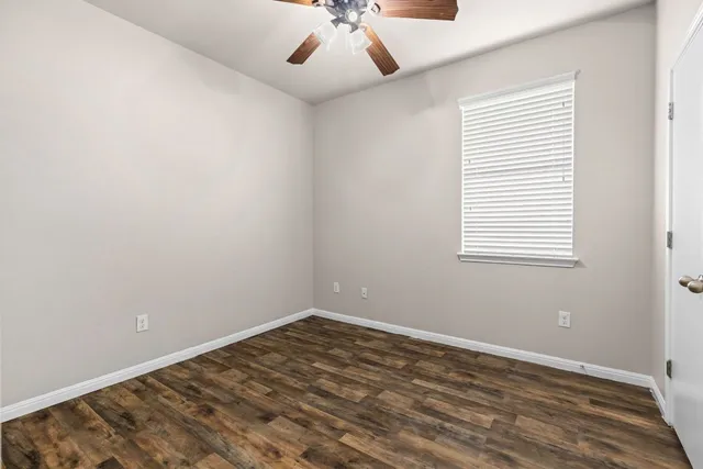 a bathroom with a granite countertop sink a toilet and bathtub