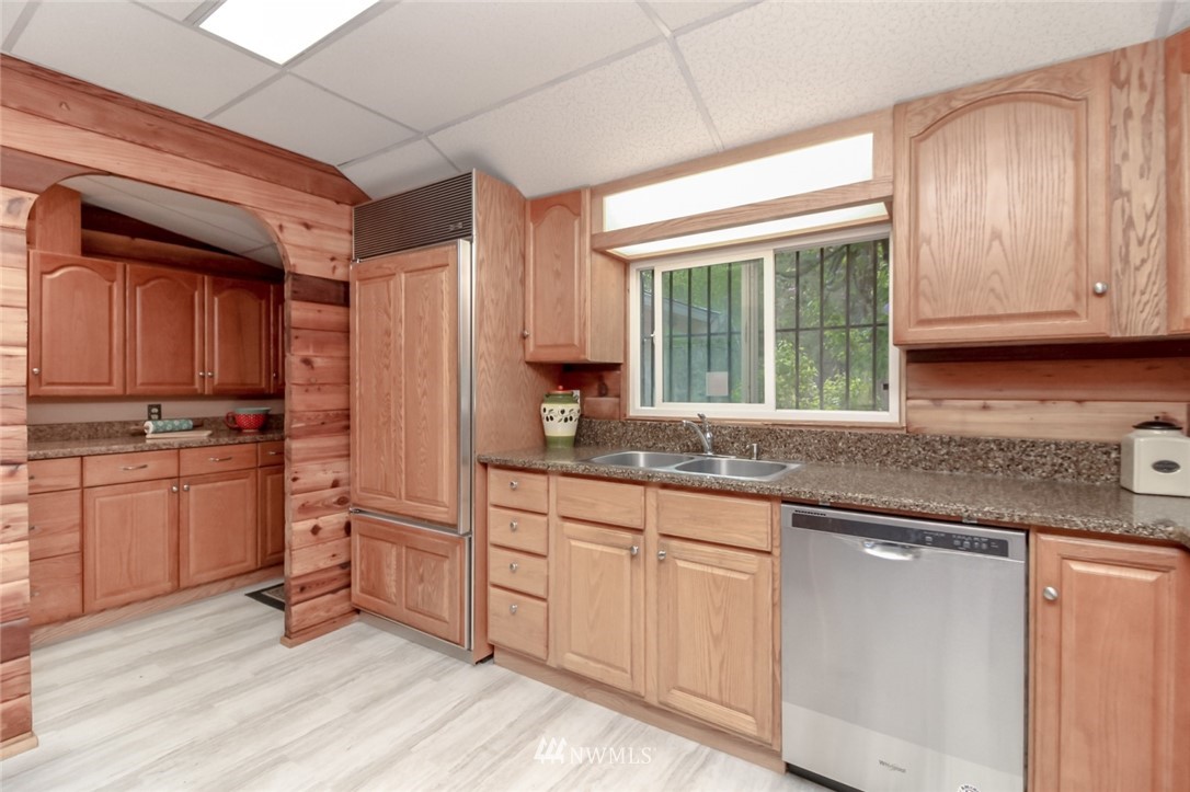 19861 Renton-Maple Valley Road Renton, WA 98058 - Photo 13 of 32 a kitchen with granite countertop a sink cabinets stainless steel appliances and a window