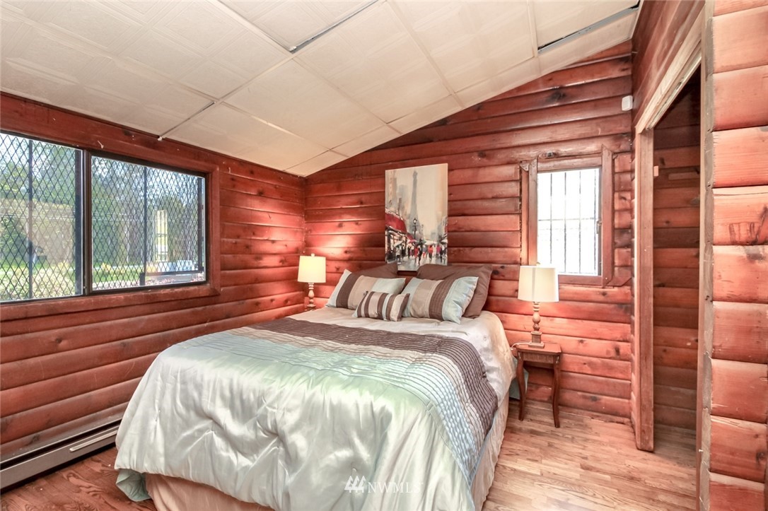 19861 Renton-Maple Valley Road Renton, WA 98058 - Photo 21 of 32 a bedroom with a bed and a large window