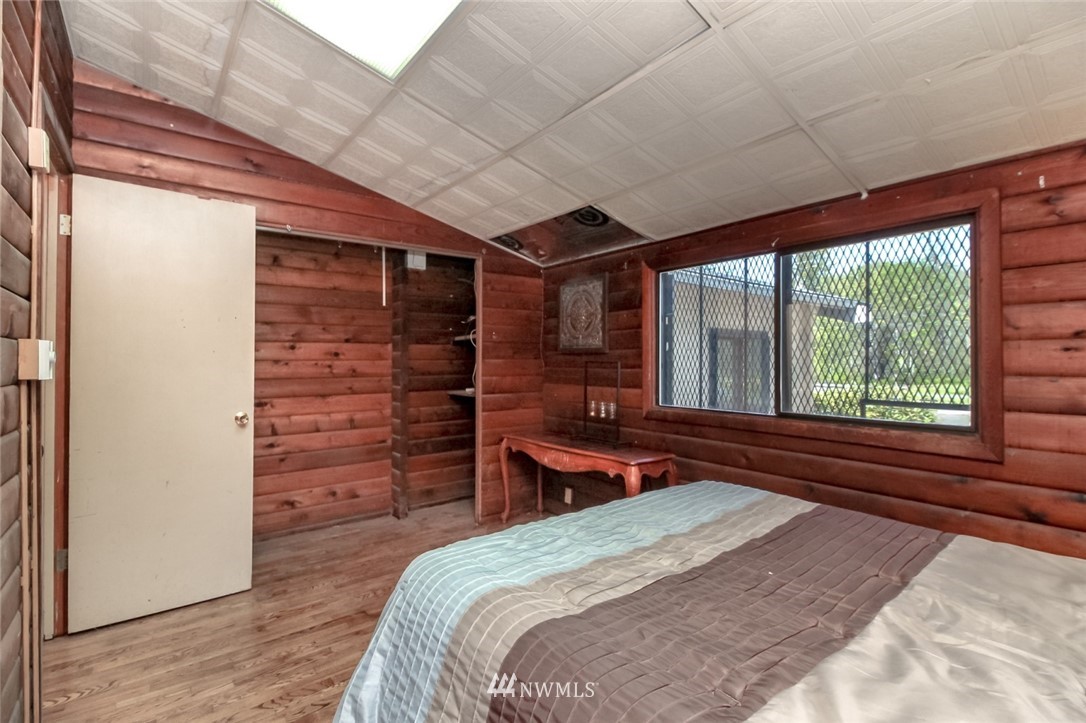 19861 Renton-Maple Valley Road Renton, WA 98058 - Photo 23 of 32 a bedroom with a bed and a large window