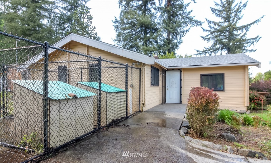19861 Renton-Maple Valley Road Renton, WA 98058 - Photo 28 of 32 a view of a house with a small yard and wooden fence